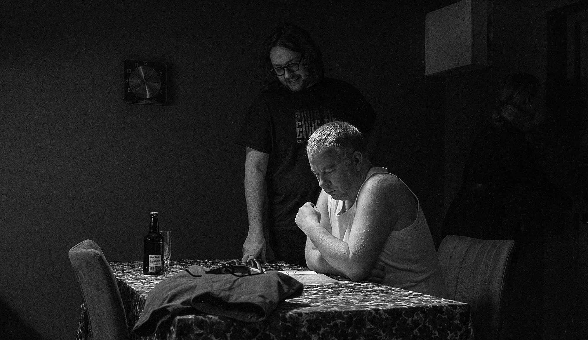 Man directing actor in scene at table